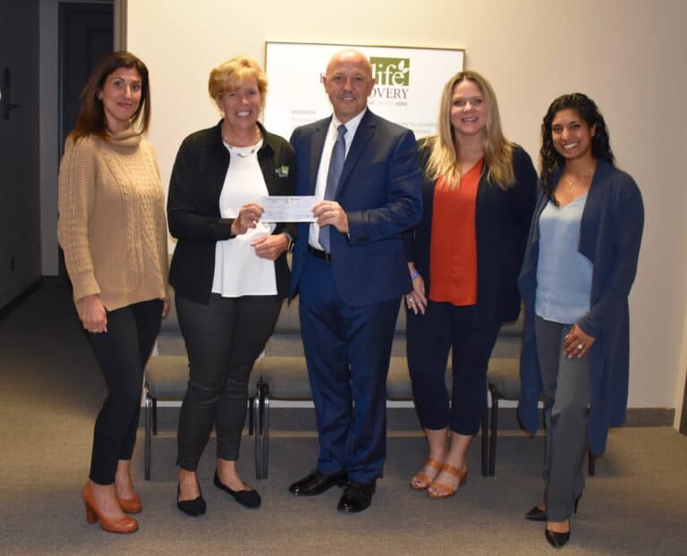 Group presenting donation check to organization.