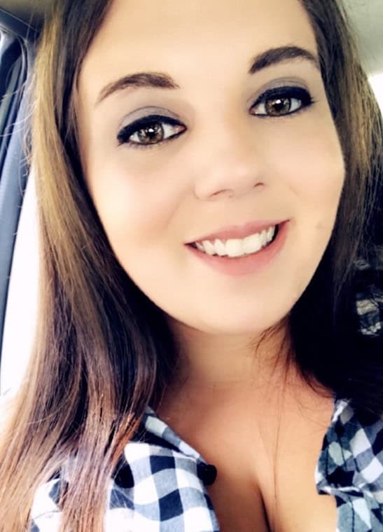 Smiling woman in checkered shirt selfie