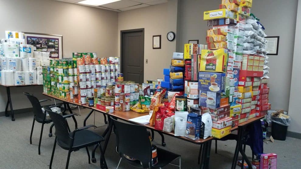 Table filled with canned and boxed food donations.