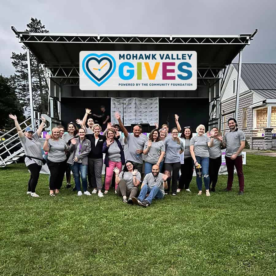 Group at Mohawk Valley Gives event, outdoor stage visible.