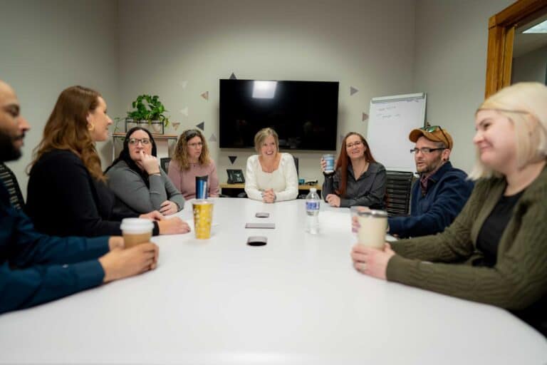 Diverse team having a meeting with coffee cups.