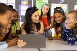 Teacher and students using a tablet in classroom