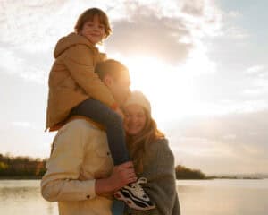 Family enjoying sunset by the lake.