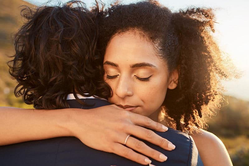 Couple embracing warmly under sunlight