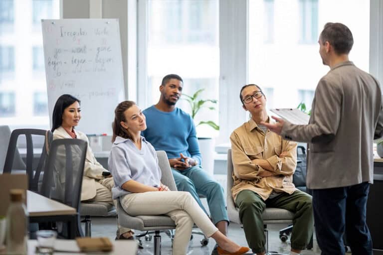 Team in meeting room discussing ideas.