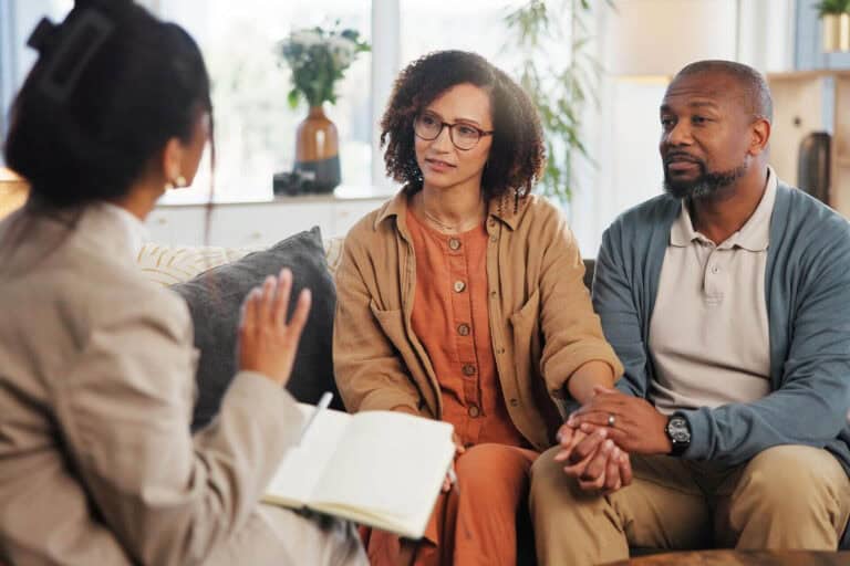 Couple holding hands in a short-term counseling session