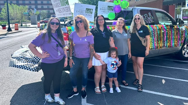 Group of people at a cheerful outdoor event.